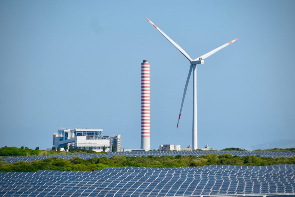 A wind farm with a wind turbine in the background